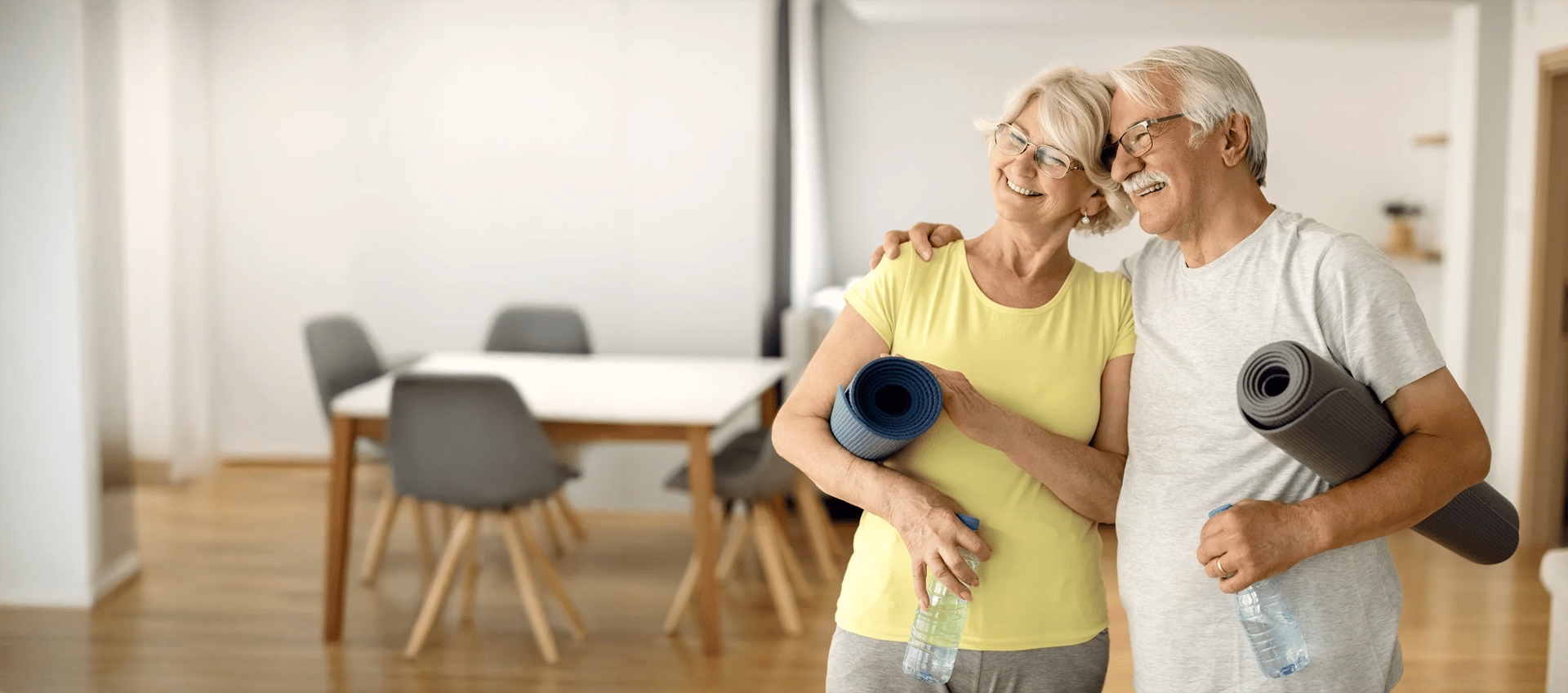 Senior couple practicing yoga, benefiting from disc decompression therapy